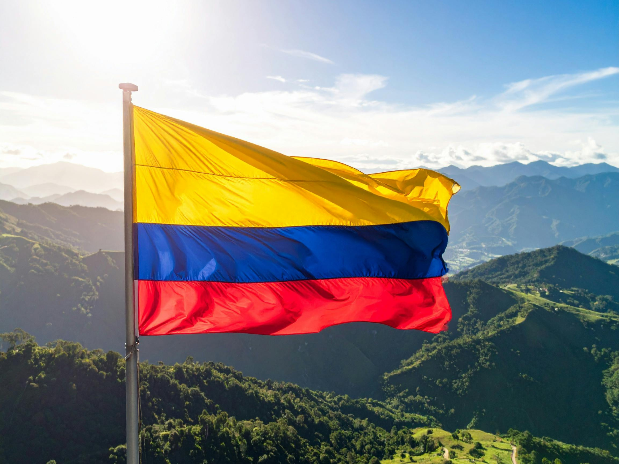 Colombian flag flying over the Andes mountains